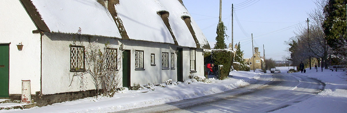 Houses by Whaddon village hall in snow